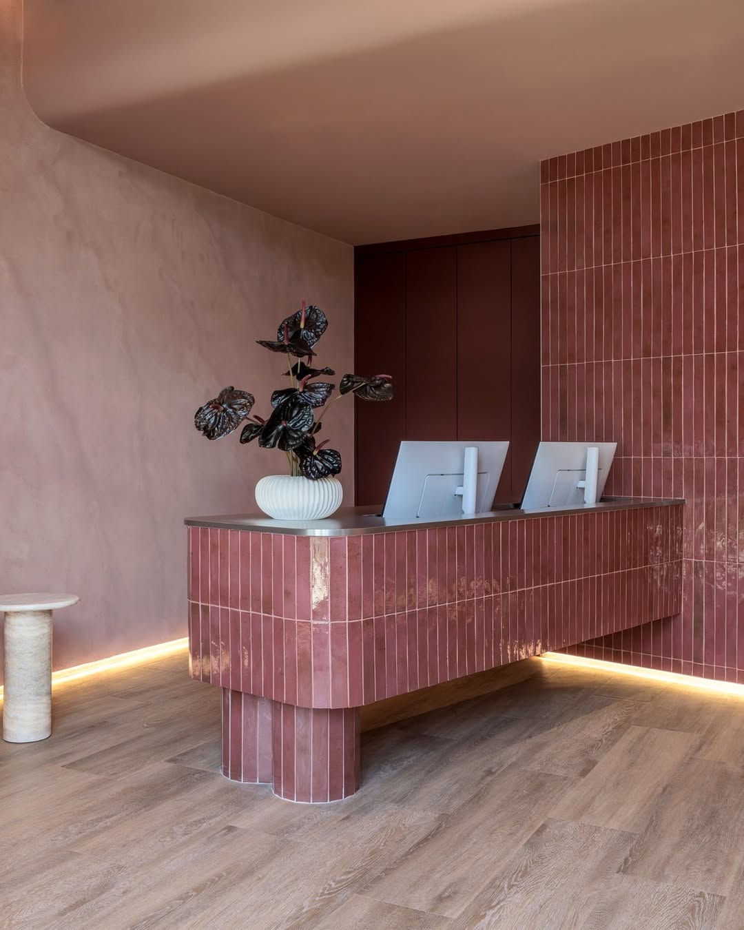 Custom reception area with vertical tile finish and wood-look flooring